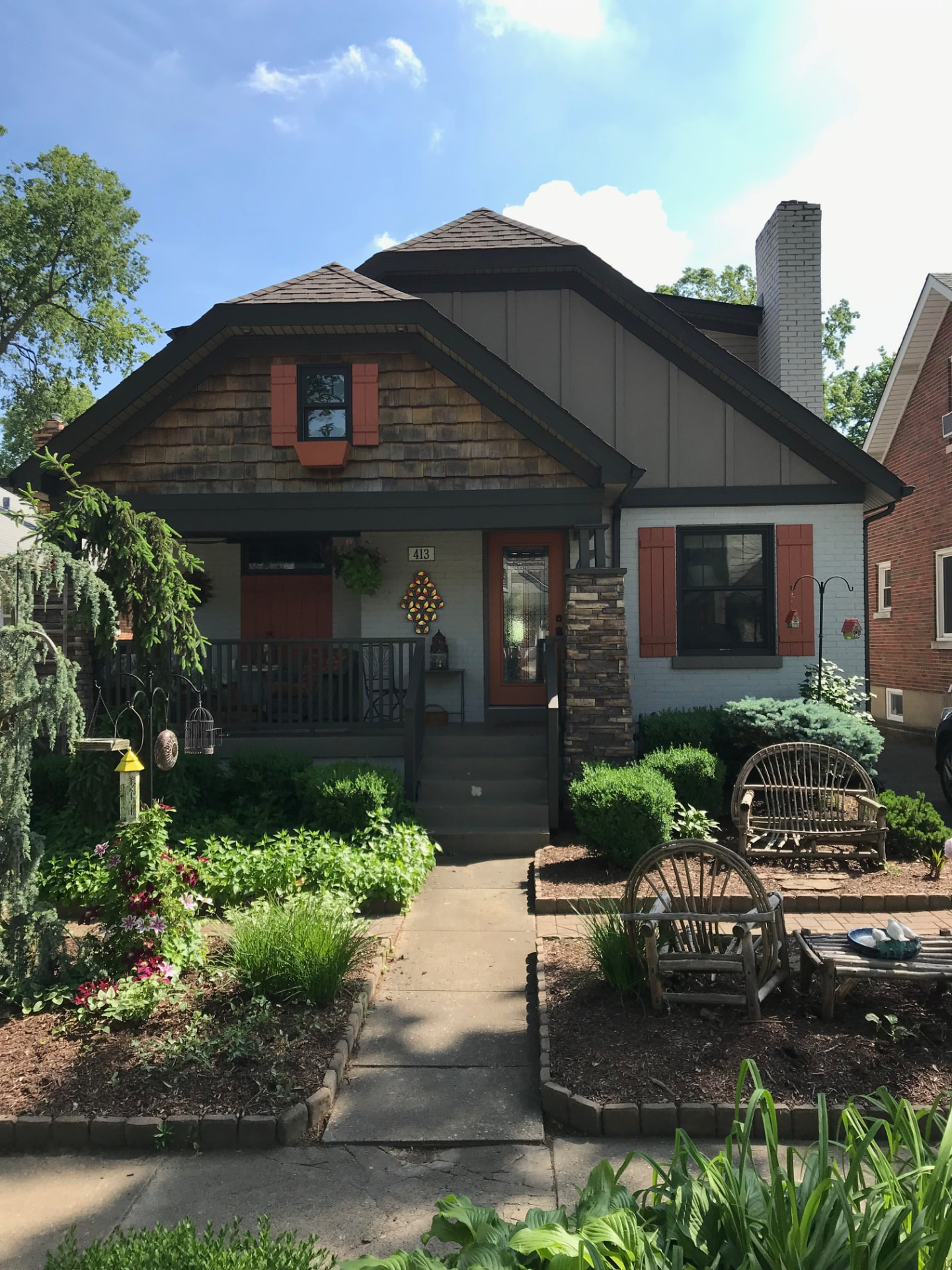 Craftsman bungalow with cedar shake gable, board-and-batten siding, stone column and a covered front porch
